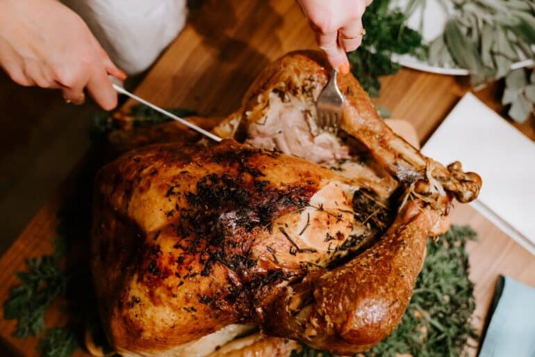 a thanksgiving turkey being carved to serve
